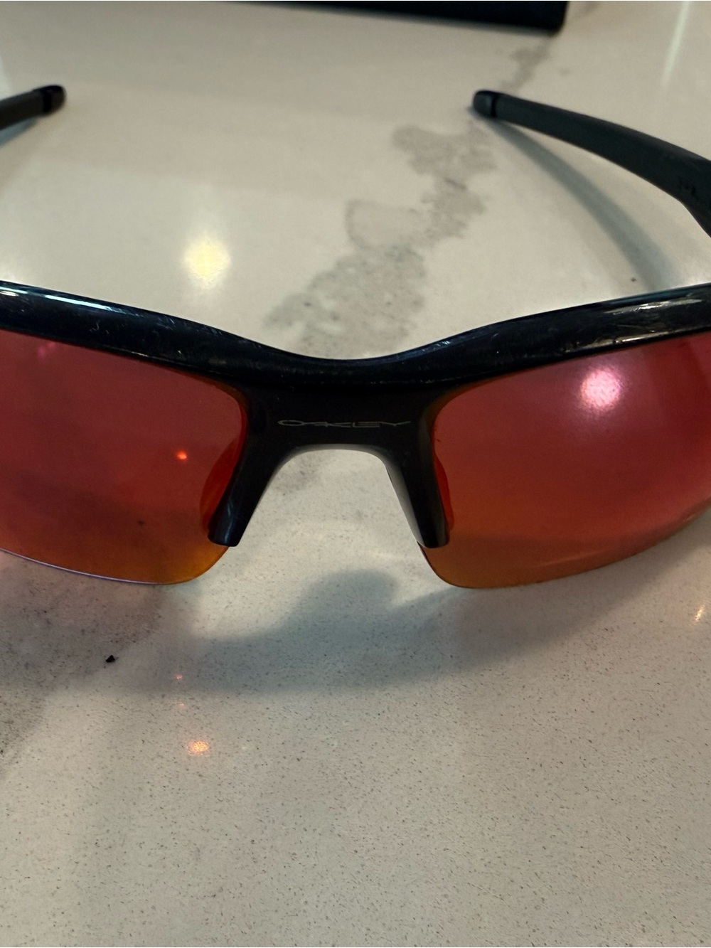 Oakley Gloss Black Frame Sunglasses with Red-Orange Mirrored Lenses